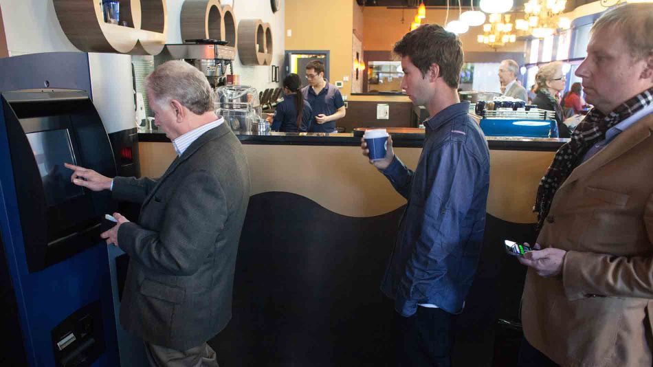 The world's first Bitcoin ATM in use at Waves Coffee House.